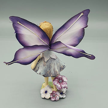 Purple Fairy with Butterfly Wings in the Garden